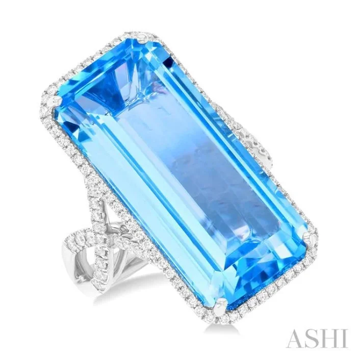 26×12 MM Emerald Cut Blue Topaz and 1/2 Ctw Round Cut Diamond Halo Semi-Precious Ring in 14K White Gold