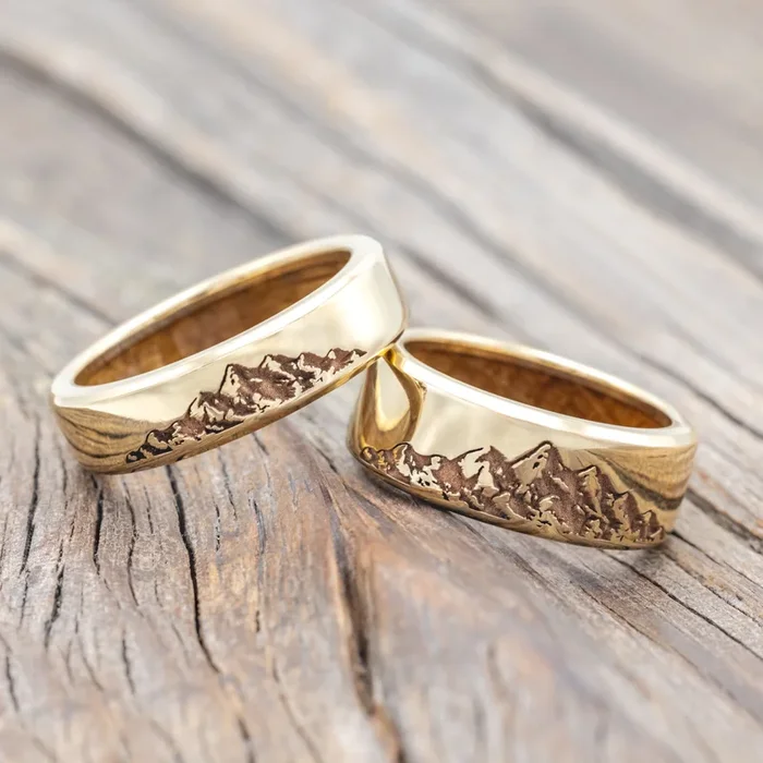 “HORIZON” – MATCHING SET OF MOUNTAIN ENGRAVED WEDDING BANDS WITH WHISKEY BARREL OAK LINING