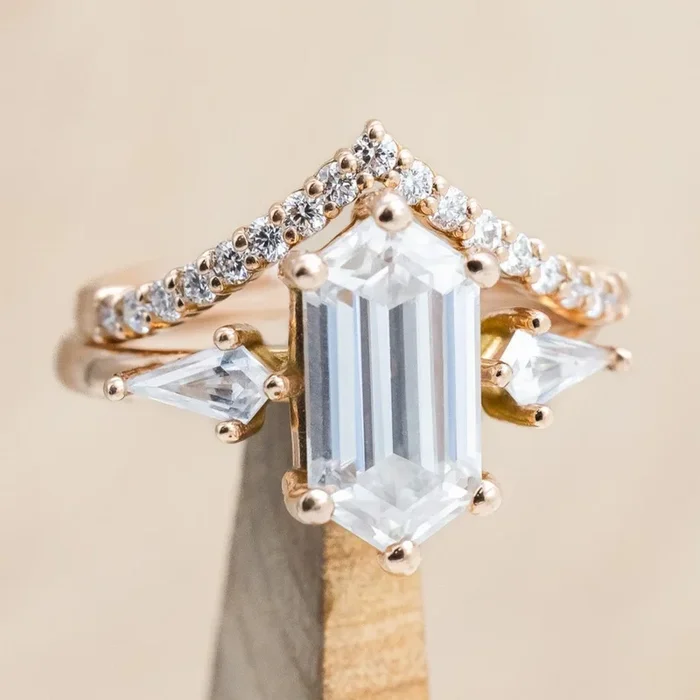 “ISLA” – ELONGATED HEXAGON CUT MOISSANITE ENGAGEMENT RING WITH MOISSANITE ACCENTS & A DIAMOND TRACER