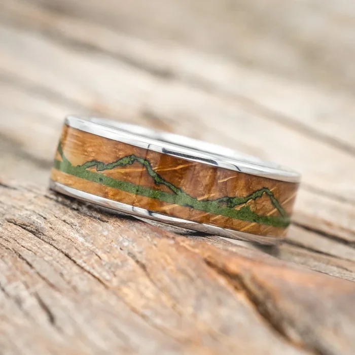 “THE EXPEDITION” – MOSS LINED WEDDING RING WITH WHISKEY BARREL INLAY AND ENGRAVED MOSS MOUNTAINS