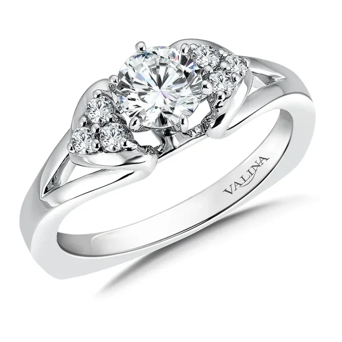 A triangle of stones flank the sides of the center diamond in this brightly polished sculpted ring design.